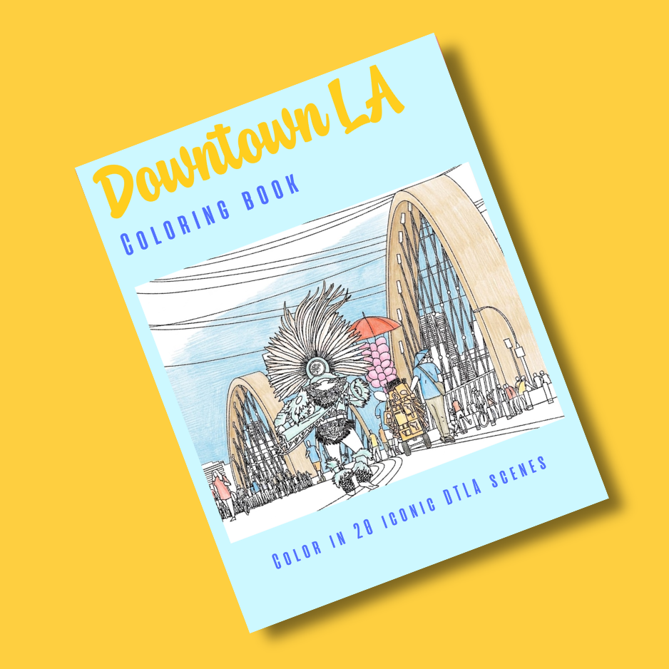 A light blue coloring book titled 'Downtown LA' with a cartoon illustration of a person in a feathered headdress walking in front of arches, shown at an angle on a solid yellow background.